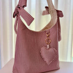 Load image into Gallery viewer, Red and white striped tote bag with a keychain on a light background
