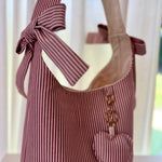 Load image into Gallery viewer, Striped tote bag with a bow and heart detail on a white background
