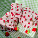 Load image into Gallery viewer, Set of strawberry-patterned cosmetic bags on a green checkered background
