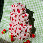 Load image into Gallery viewer, Stack of strawberry-patterned bags on a green checkered background
