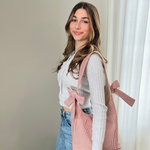 Load image into Gallery viewer, Woman holding a pink tote bag with bows against a neutral wall.
