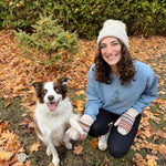 Load image into Gallery viewer, Woman and dog sitting together in a garden with fallen leaves
